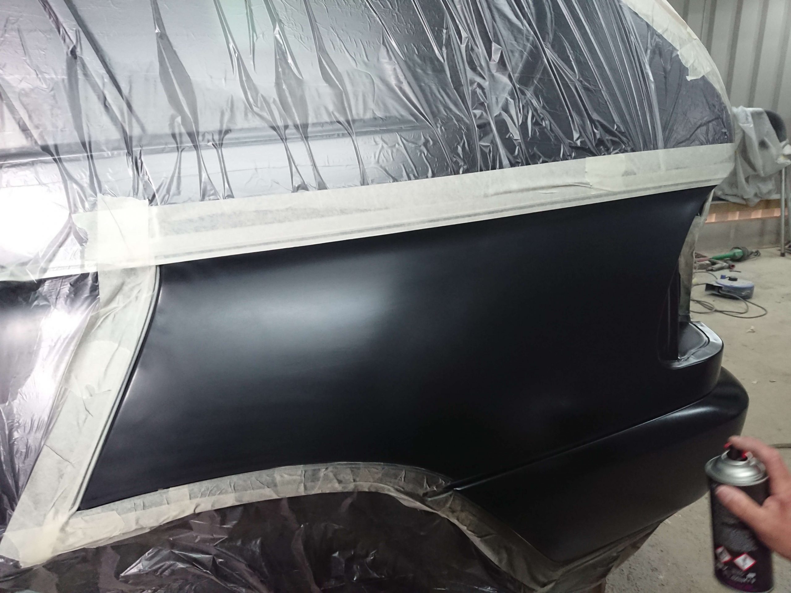 Black Spray Painting Back Of Car