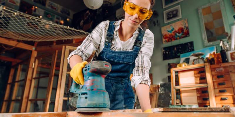 woman upcycling old furniture