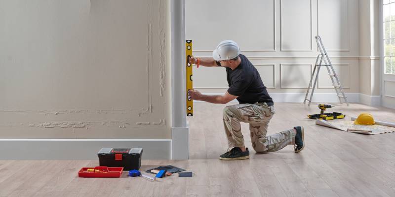 Man measuring wall
